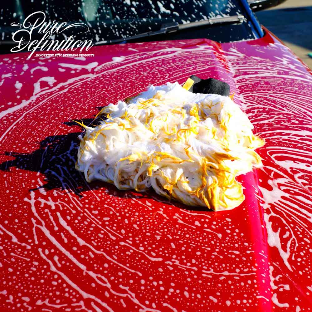 Wool wash mitt on Range Rover bonnet covered in foam suds.