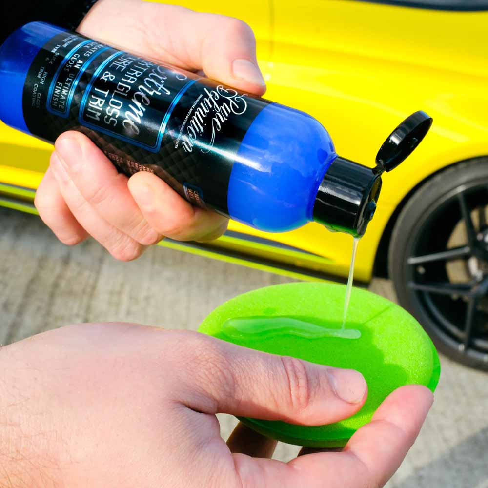 pouring extreme extra gloss tyre gel onto a green applicator pad