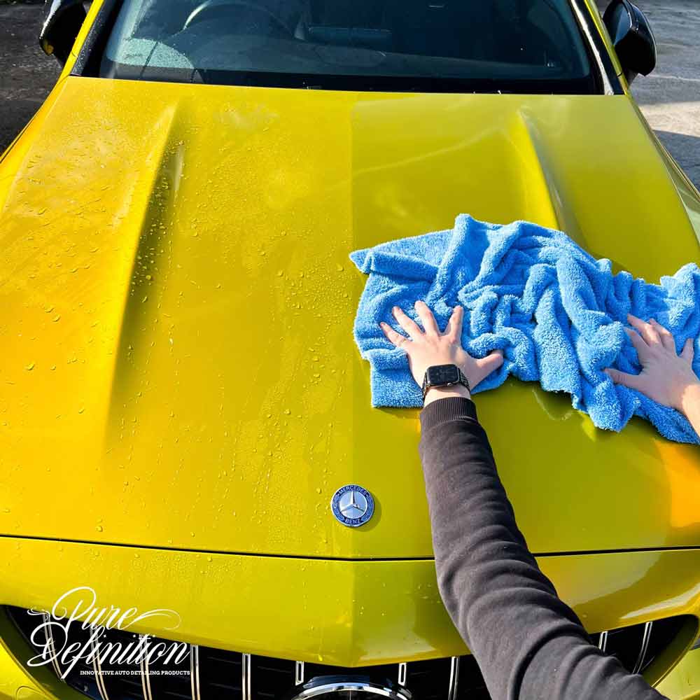 blue edgeless towel drying yellow c63 amg bonnet