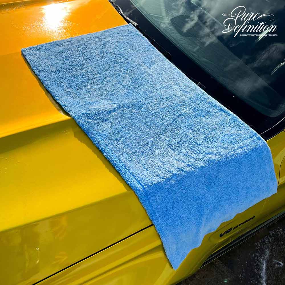 blue edgeless drying towel laying on c63 amg car bonnet