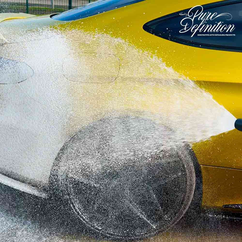 spraying ultra wash snow foam onto a yellow c63 amg