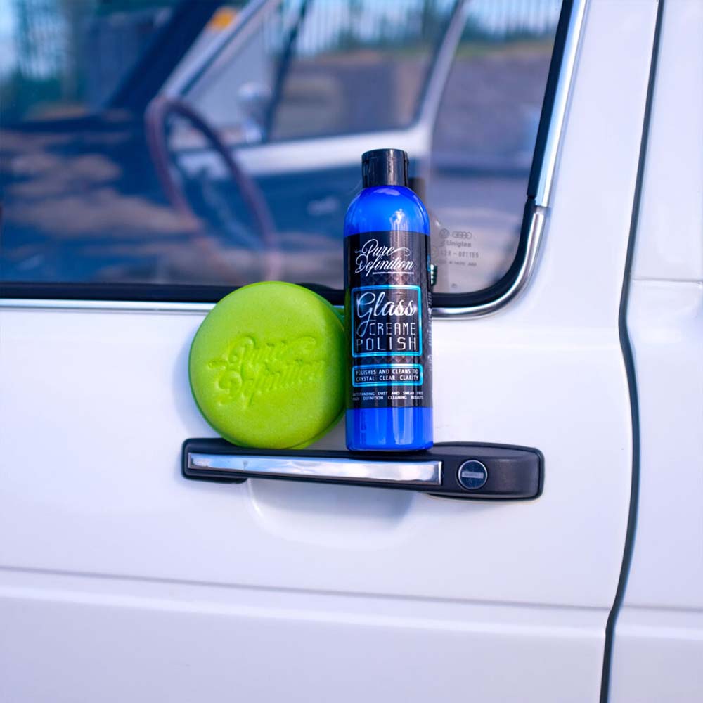 glass creame polish window cleaner bottle and pad on the door handle of a vw caddy