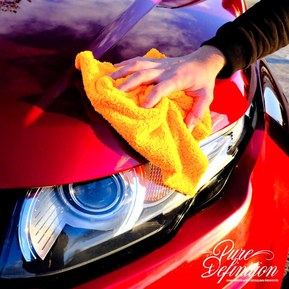 wiping away h20 wax from a red Range Rover