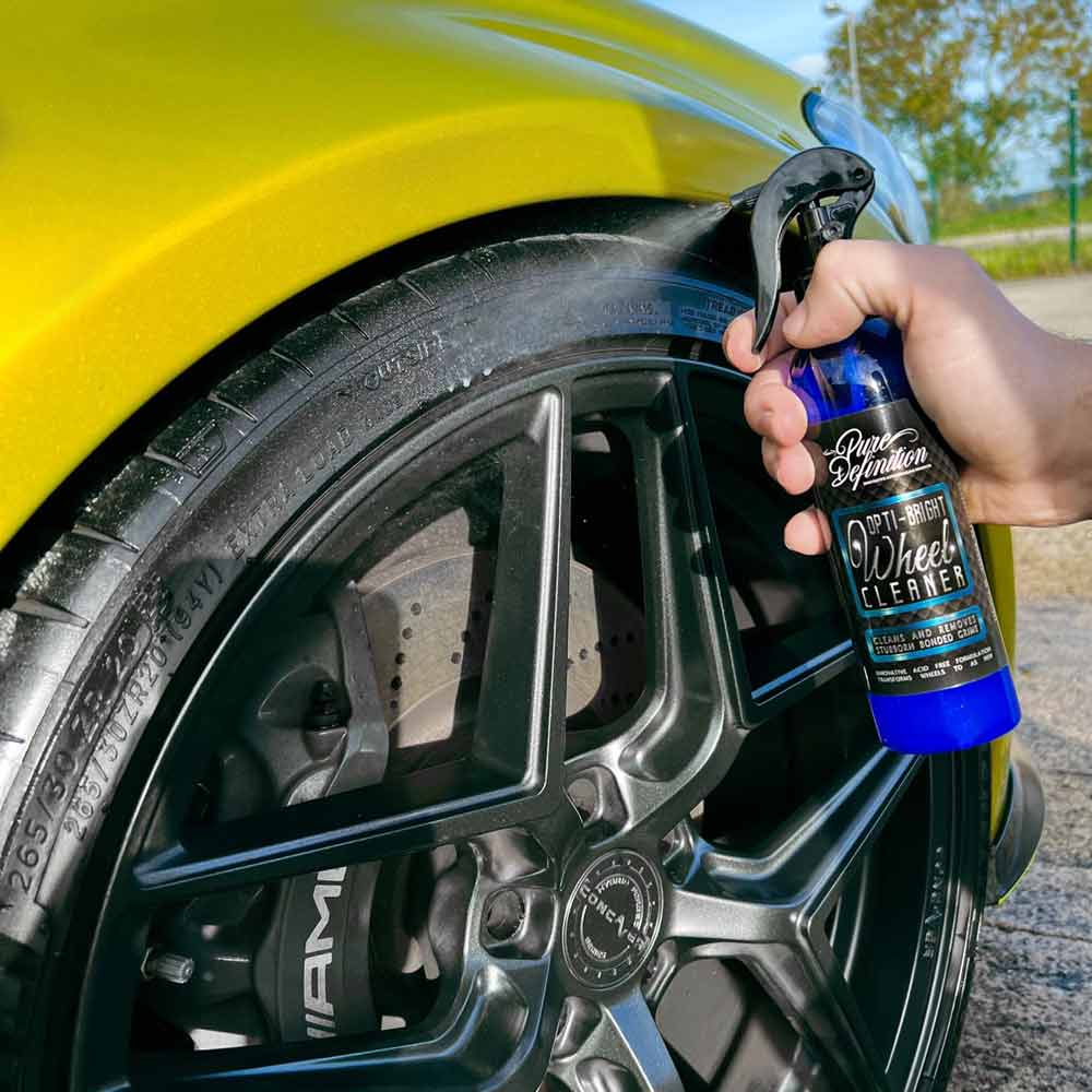 cleaning a car tyre with Opti bright wheel cleaner